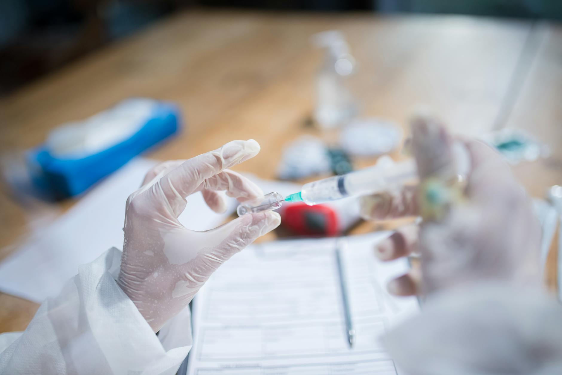 close up of a person holding a syringe